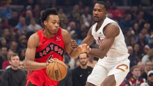 Toronto Raptors' Scottie Barnes, left, drives against Cleveland Cavaliers' Evan Mobley, right, during the first half of an NBA basketball game in Cleveland, Thursday, Nov. 13, 2025. (Phil Long/AP)